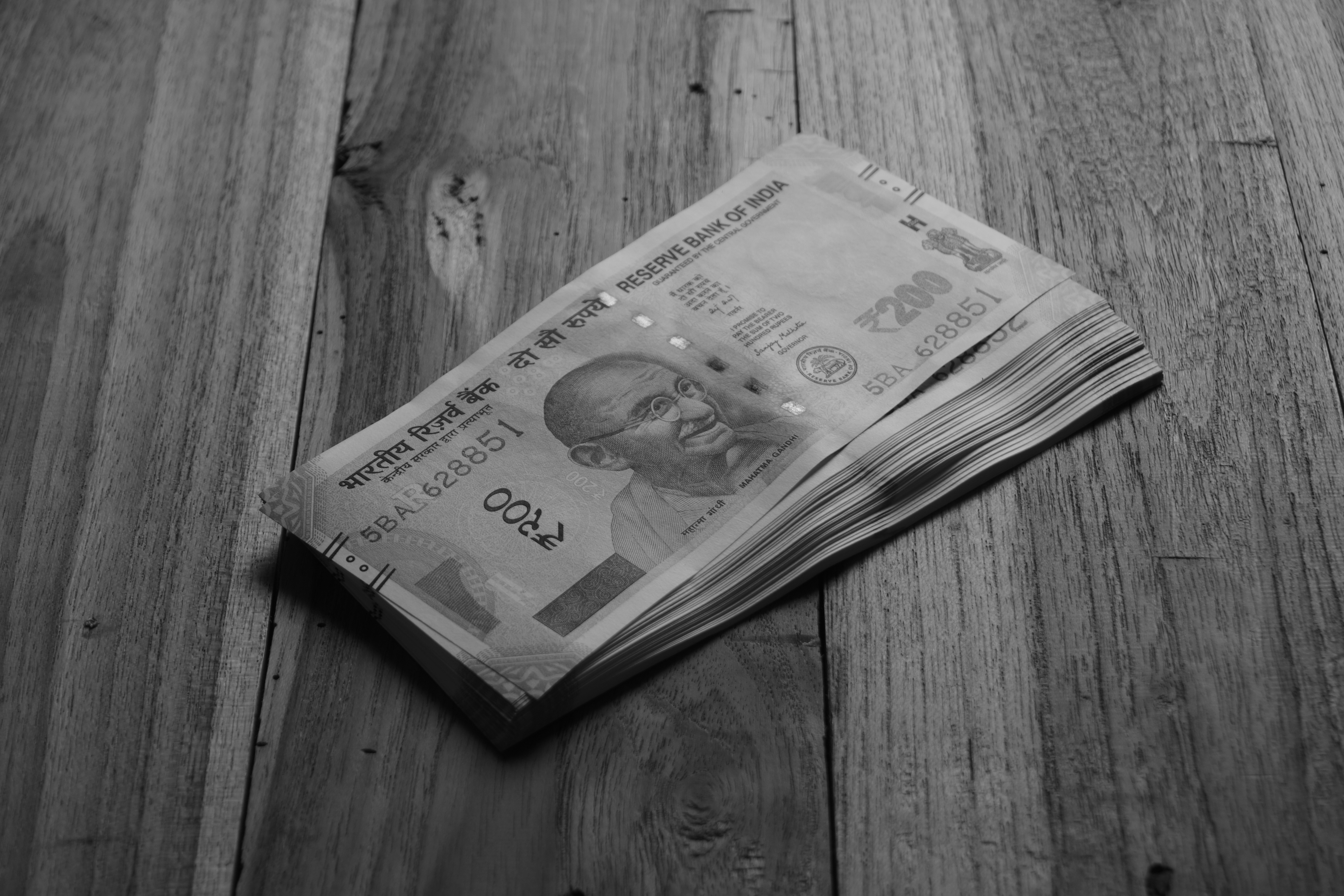 a-stack-of-indian-rupees-on-wood. - thorium (unsplash)./pho
