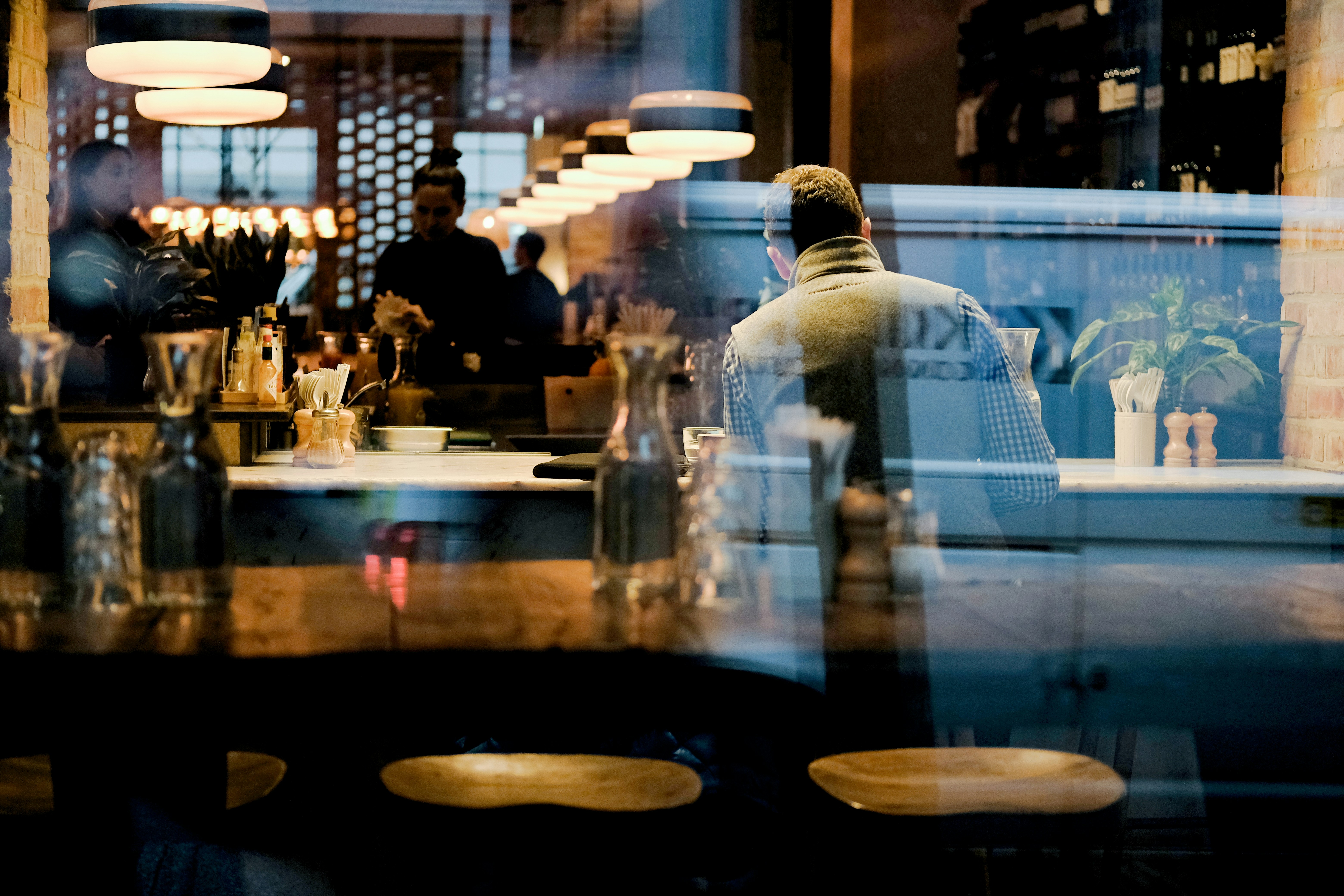 man-in-white-dress-shirt-standing-near-table - kevin-grieve (unsplash)./pho